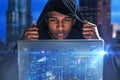 Hacker with laptop in night city Royalty Free Stock Photo