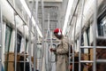 Black hipster man wear wireless headphones, listening to the music, using smartphone in subway train Royalty Free Stock Photo