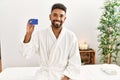 Young african american holding credit card at beauty center Royalty Free Stock Photo