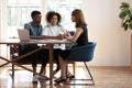 Young biracial couple consulting talking with female designer at meeting Royalty Free Stock Photo