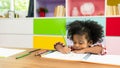 Young African American kid girl drawing, child study at home school. Children education, homeschooling concept