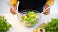 Young african american lady in apron prepare salad at table with organic vegetables in kitchen interior, top view Royalty Free Stock Photo