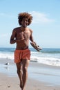 Young african american male running on beach Royalty Free Stock Photo