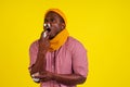 Young african american male wearing red checkered shirt with knitted scarf and hat bad unwell with fever heat and chills Royalty Free Stock Photo