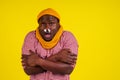 Young african american male wearing red checkered shirt with knitted scarf and hat feeling bad unwell with fever heat Royalty Free Stock Photo