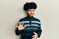 Young african american man with afro hair wearing casual clothes disgusted expression, displeased and fearful doing disgust face Royalty Free Stock Photo