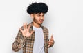 Young african american man with afro hair wearing casual clothes disgusted expression, displeased and fearful doing disgust face Royalty Free Stock Photo