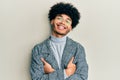 Young african american man with afro hair wearing casual clothes  glasses happy face smiling with crossed arms looking at the Royalty Free Stock Photo