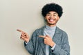 Young african american man with afro hair wearing casual clothes  glasses smiling and looking at the camera pointing with two Royalty Free Stock Photo