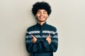 Young african american man with afro hair wearing casual clothes happy face smiling with crossed arms looking at the camera Royalty Free Stock Photo