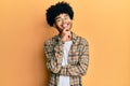 Young african american man with afro hair wearing casual clothes smiling looking confident at the camera with crossed arms and Royalty Free Stock Photo