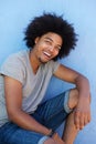 Young african american man with afro smiling