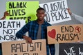 Young african american man with anti racist letterings