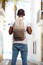 Young african american man with bag standing in street