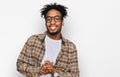 Young african american man with beard wearing casual clothes and glasses with hands together and crossed fingers smiling relaxed Royalty Free Stock Photo