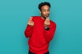 Young african american man with beard wearing casual winter sweater doing money gesture with hands, asking for salary payment, Royalty Free Stock Photo