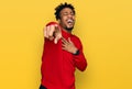 Young african american man with beard wearing casual winter sweater laughing at you, pointing finger to the camera with hand over Royalty Free Stock Photo