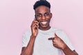 Young african american man having conversation talking on the smartphone pointing finger to one self smiling happy and proud Royalty Free Stock Photo