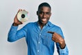 Young african american man holding compact disc pointing finger to one self smiling happy and proud Royalty Free Stock Photo