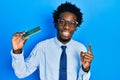 Young african american man holding computer ram smiling with an idea or question pointing finger with happy face, number one Royalty Free Stock Photo