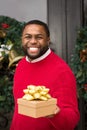 Young African American man holding a gift. Royalty Free Stock Photo