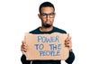 Young african american man holding power to the people banner depressed and worry for distress, crying angry and afraid