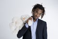 Young African American man holding teddy bear