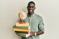 Young african american man holding vintage world ball and books smiling with a happy and cool smile on face Royalty Free Stock Photo