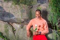 Young African American Man holding white flower, waiting for you Royalty Free Stock Photo