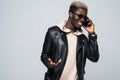 Young African American man making a phone call on her smartphone isolated on gray Royalty Free Stock Photo