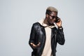 Young African American man making a phone call on her smartphone isolated on gray Royalty Free Stock Photo