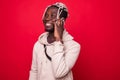 Young African American man making a phone call on her smartphone isolated on red background Royalty Free Stock Photo