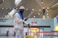 African American man passenger looking at mobile boarding pass on smartphone in check-in area Royalty Free Stock Photo