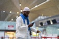 African American man passenger looking at mobile boarding pass on smartphone in check-in area Royalty Free Stock Photo