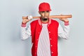 Young african american man playing baseball holding bat and ball depressed and worry for distress, crying angry and afraid Royalty Free Stock Photo