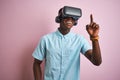 Young african american man playing virtual reality game using goggles Royalty Free Stock Photo
