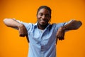 Young african american man pointing at copy space over yellow background Royalty Free Stock Photo