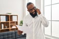 Young african american man psychologist talking on the smartphone at psychology center Royalty Free Stock Photo