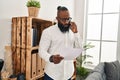 Young african american man psychologist talking on the smartphone at psychology center Royalty Free Stock Photo