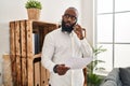 Young african american man psychologist talking on the smartphone at psychology center Royalty Free Stock Photo