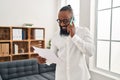 Young african american man psychologist talking on the smartphone at psychology center Royalty Free Stock Photo