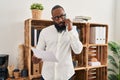 Young african american man psychologist talking on the smartphone at psychology center Royalty Free Stock Photo