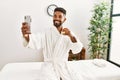 Young african american man relaxed making selfie by the smartphone drinking champagne at beauty center Royalty Free Stock Photo