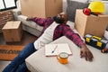 Young african american man relaxed sitting on floor at new home Royalty Free Stock Photo