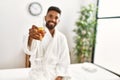 Young african american man relaxed smiling happy drinking champagne at beauty center Royalty Free Stock Photo