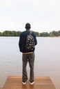 Young African American Man relaxing at Park near lake. Royalty Free Stock Photo