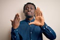 Young african american man showing golden marriage ring on finger over white background with open hand doing stop sign with Royalty Free Stock Photo