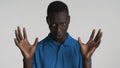 Young African American man showing wow gesture looking sly on camera over white background Royalty Free Stock Photo