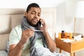 Young Man Wrapped in Scarf Making a Phone Call Royalty Free Stock Photo