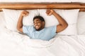 Young african-american man sleeping in bed top view Royalty Free Stock Photo